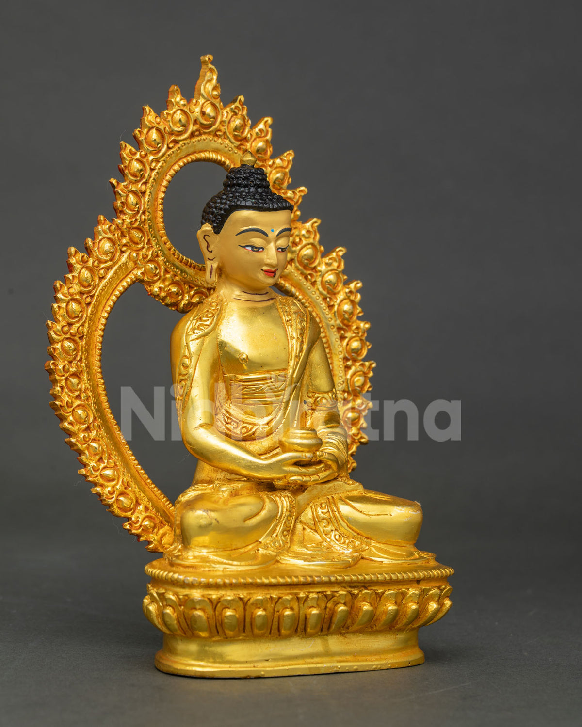 Three-quarter side view of gold Amitabha Buddha statue holding alms bowl in meditation pose