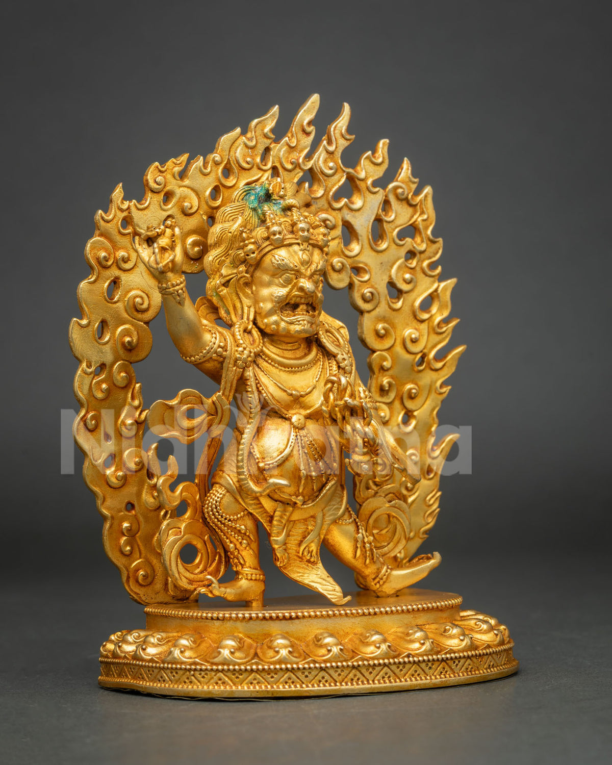 Three-quarter side view of handcrafted copper Vajrapani statue with fire-gilded finish