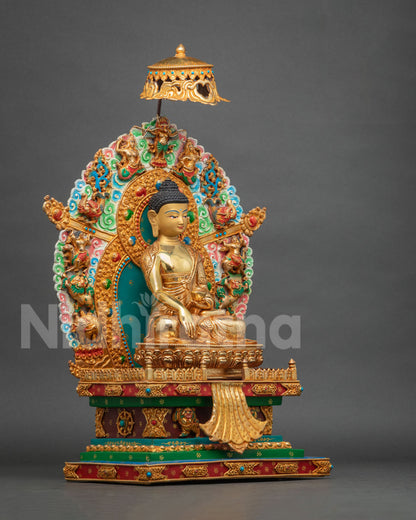 Three-quarter side view of Shakyamuni Buddha statue on throne showing gold fire-gilding and detailed halo