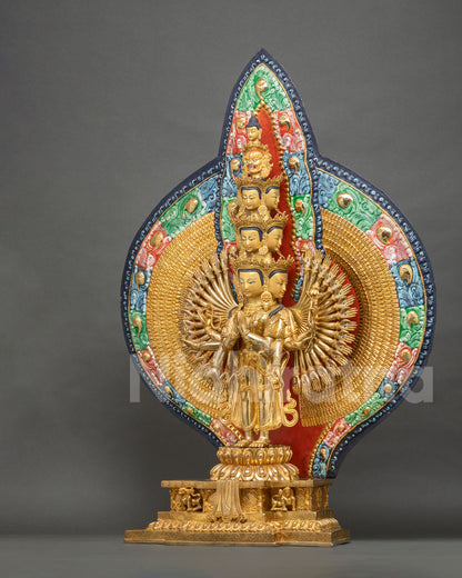 Three-quarter view of 1000-armed Avalokiteshvara statue with colorful backdrop and lion throne