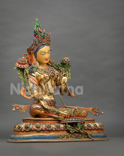 Three-quarter view of gold Green Tara sculpture seated in Lalitasana on a hand-painted lotus base