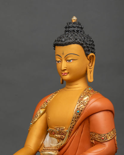 Three-quarter view of Shakyamuni Buddha statue upper body with gold gilded robe and jewels