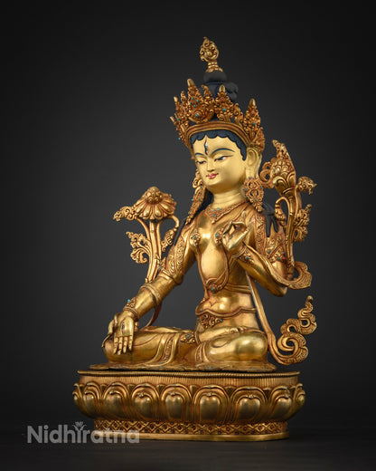 Three-quarter view of White Tara statue highlighting gold Himalayan metalwork and lotus pedestal