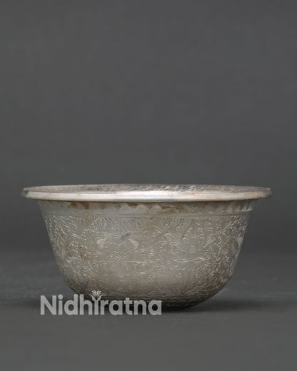 Tibetan Buddhist water offering bowl with hand carved floral motifs.