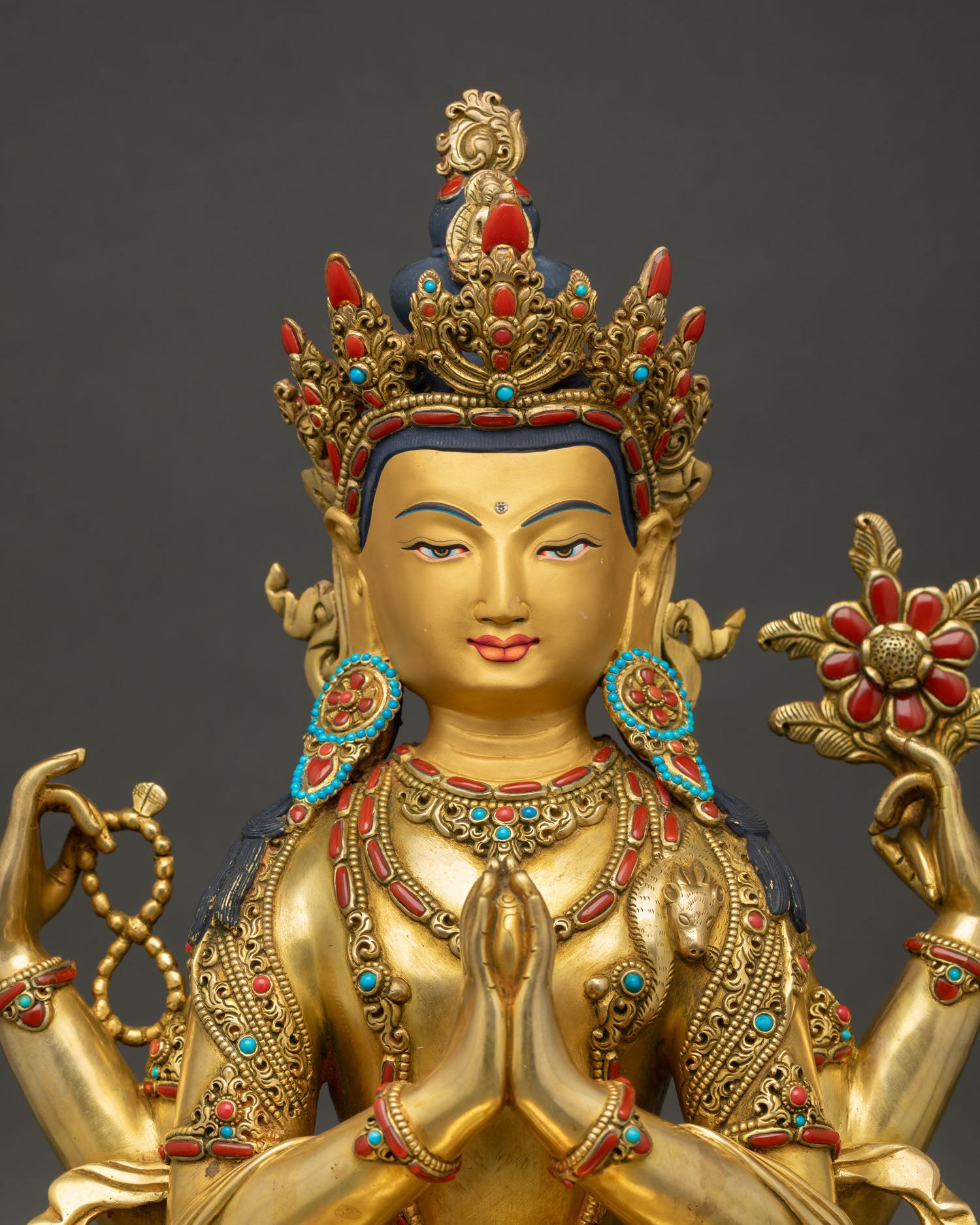 Tibetan Chenrezig statue close up showing intricate jewelry, lotus seat, and handcrafted Himalayan details