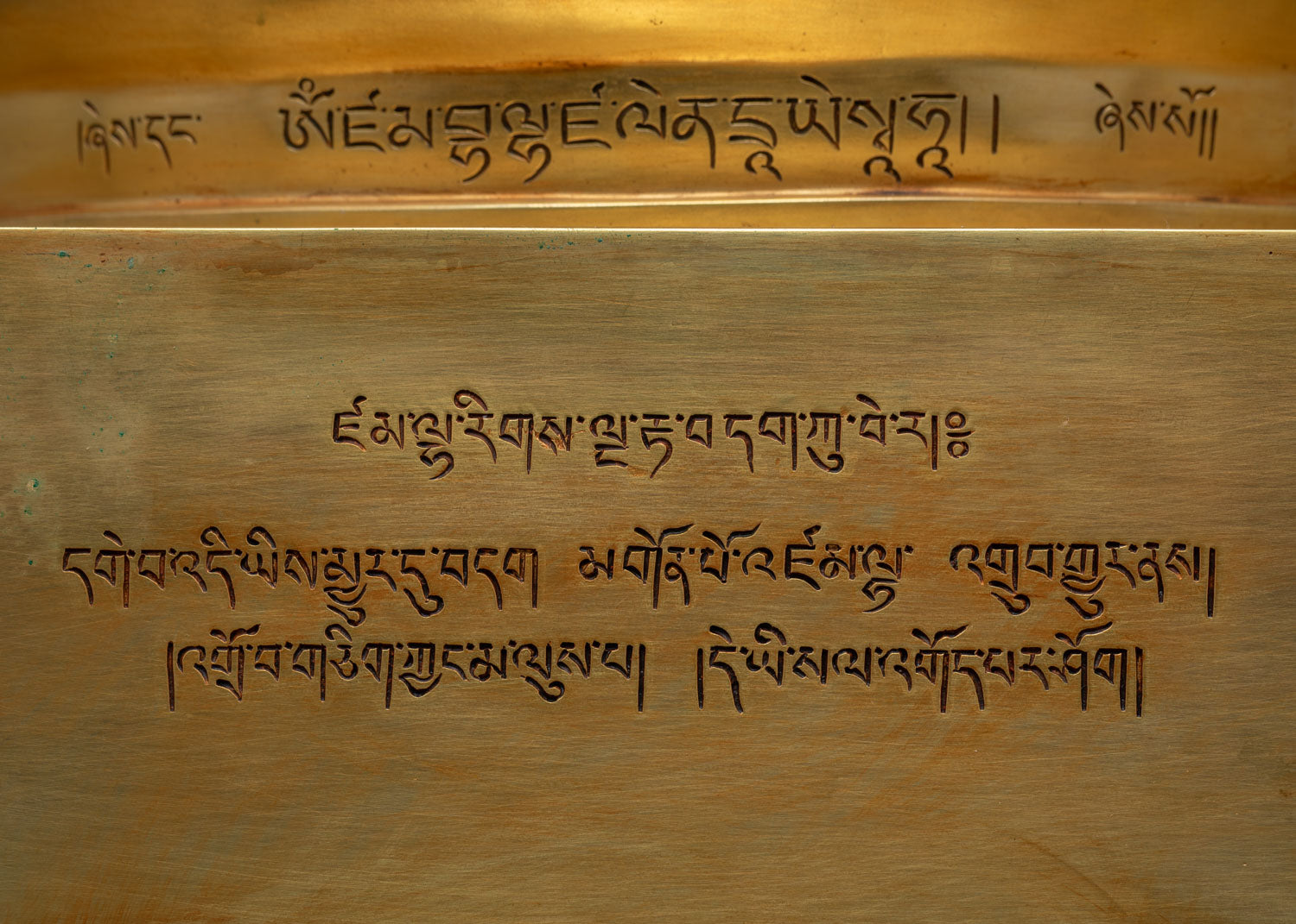 Tibetan script inscription engraved on the base of Dzambhala Statue
