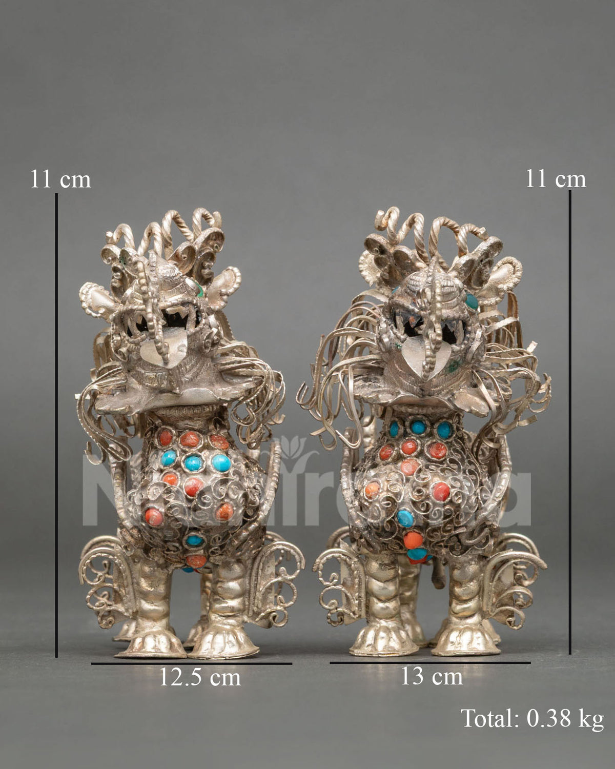 Tibetan Snow Lion Set handcrafted from copper with silver plated finish by skilled Newari artisans from Patan Nepal.