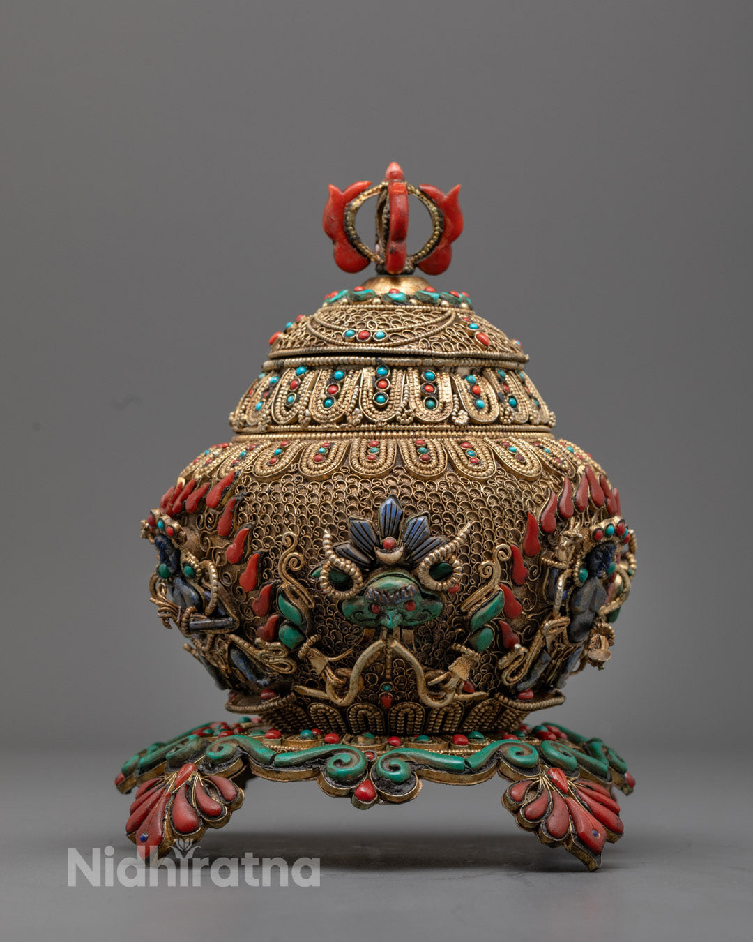 tibetan rice pot front view with filigree, gold finish, and deity carvings