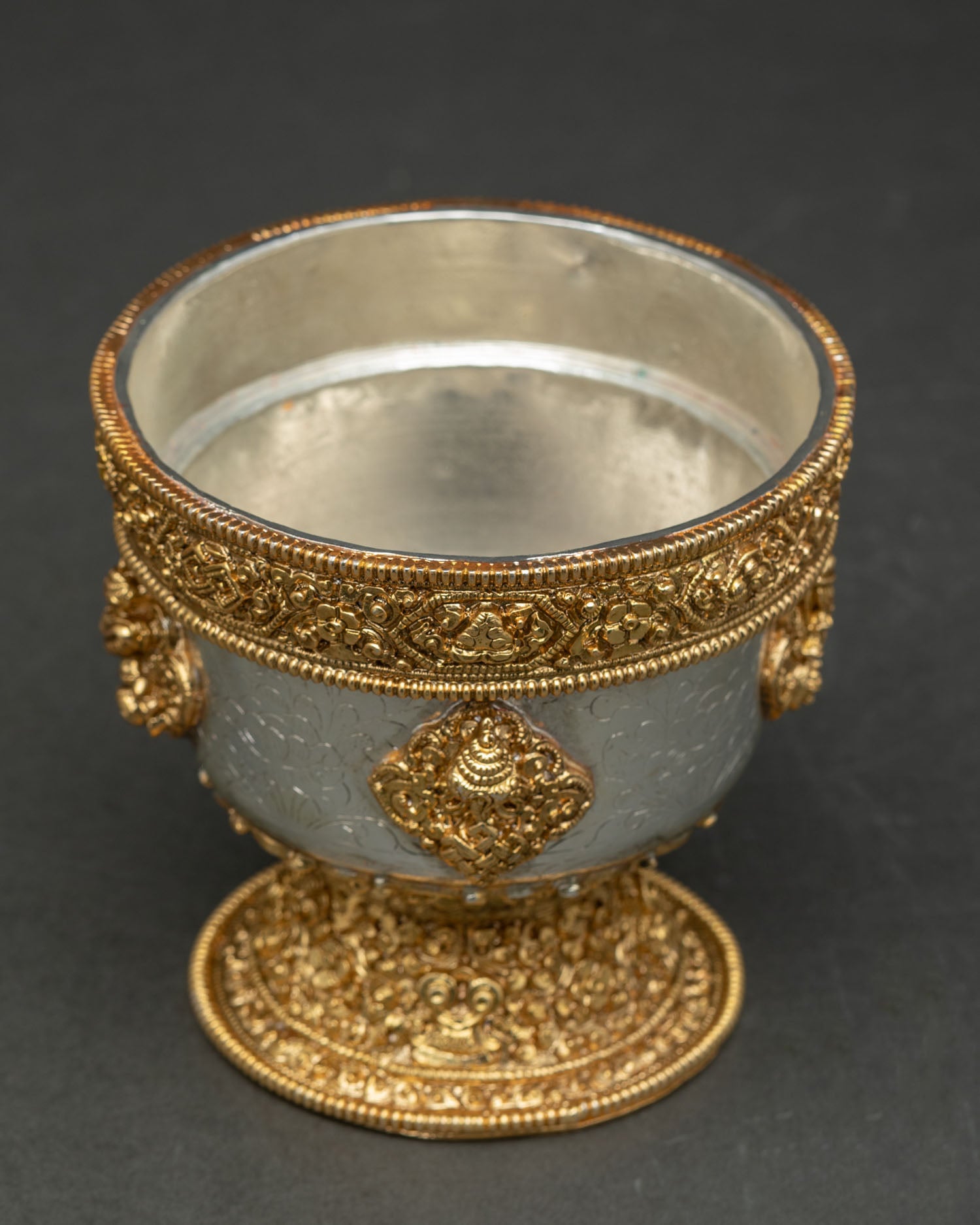 Top view water offering bowl set displaying symmetrical arrangement of seven ritual vessels with gold and silver plated finish