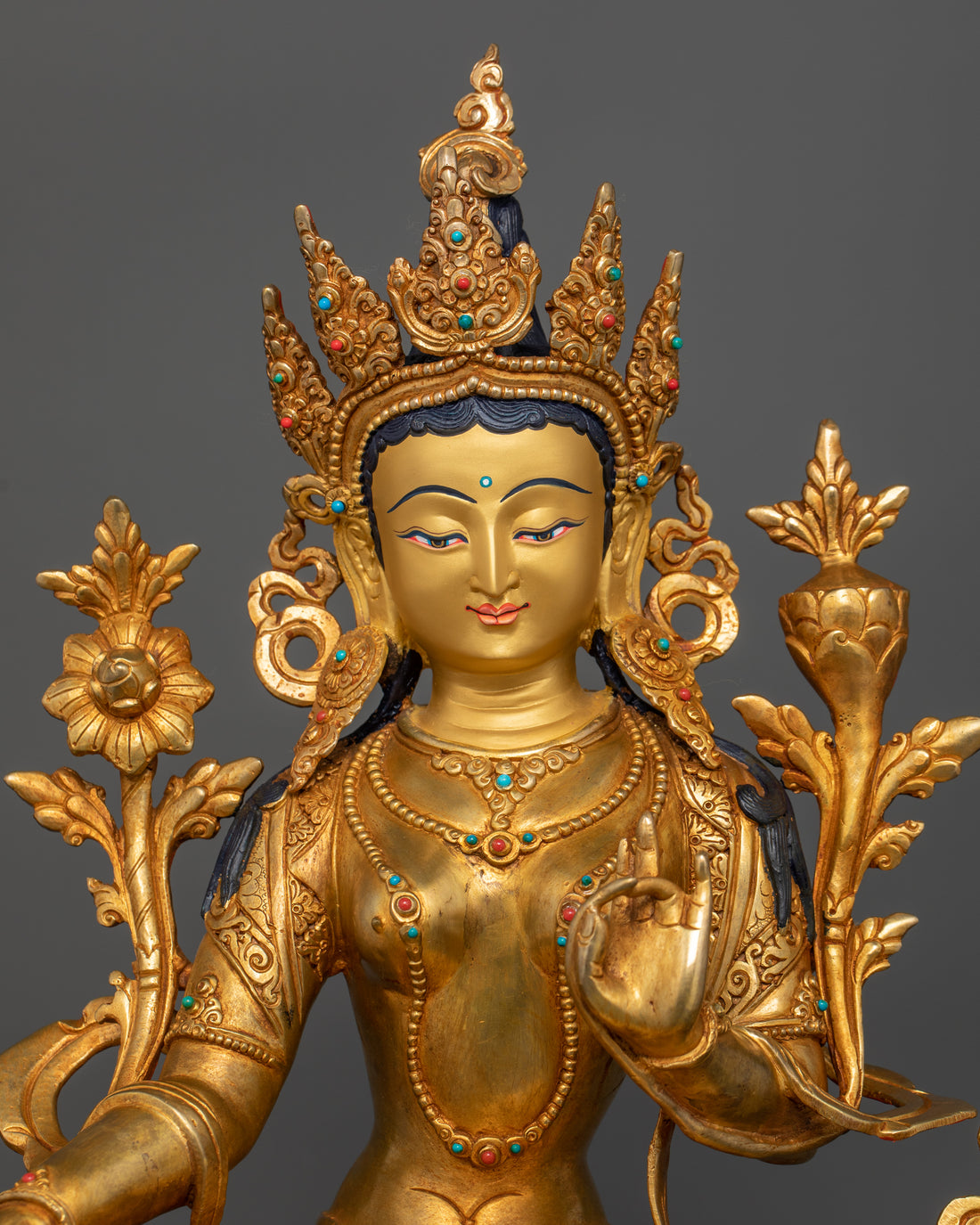 green tara statue showing the 24 karat pure gold coated face