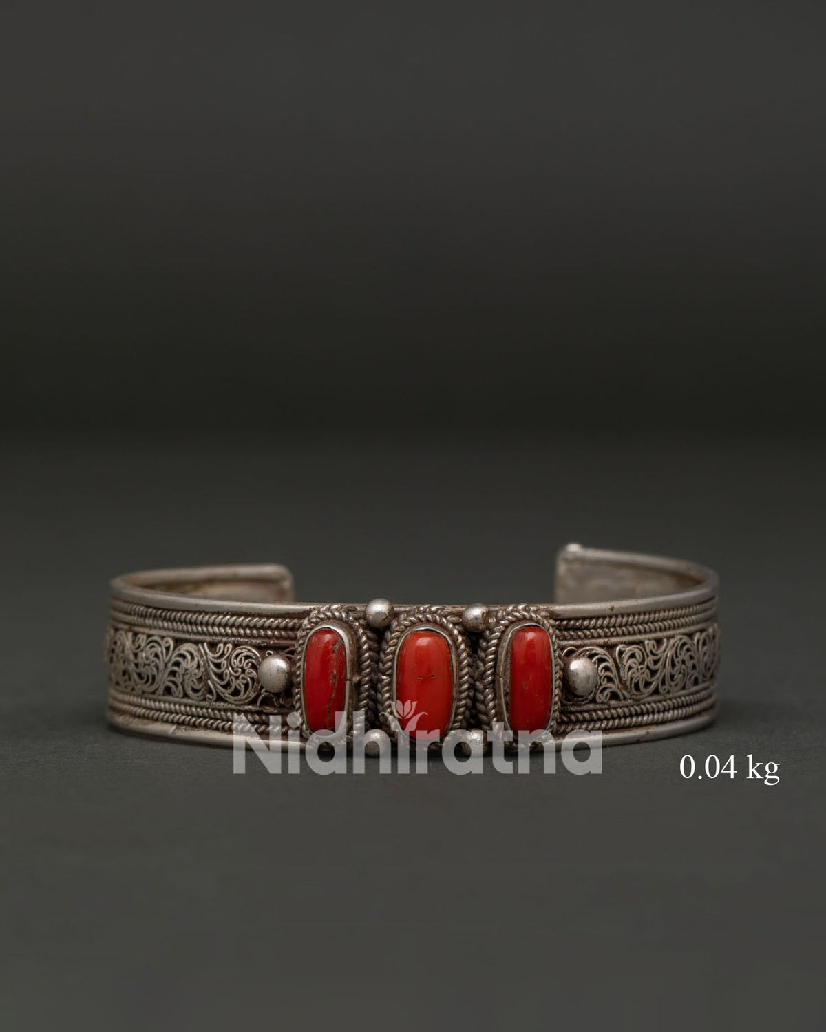 Traditional Himalayan bracelet with red coral stones and silver scrollwork