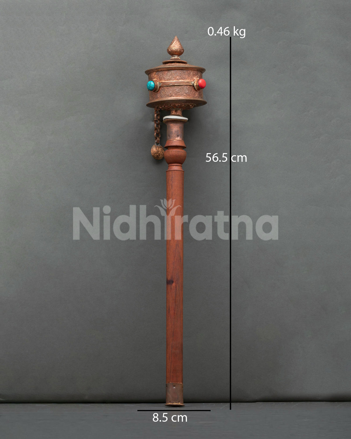 Traditional himalayan prayer wheel adorned with semi precious stones and floral design.