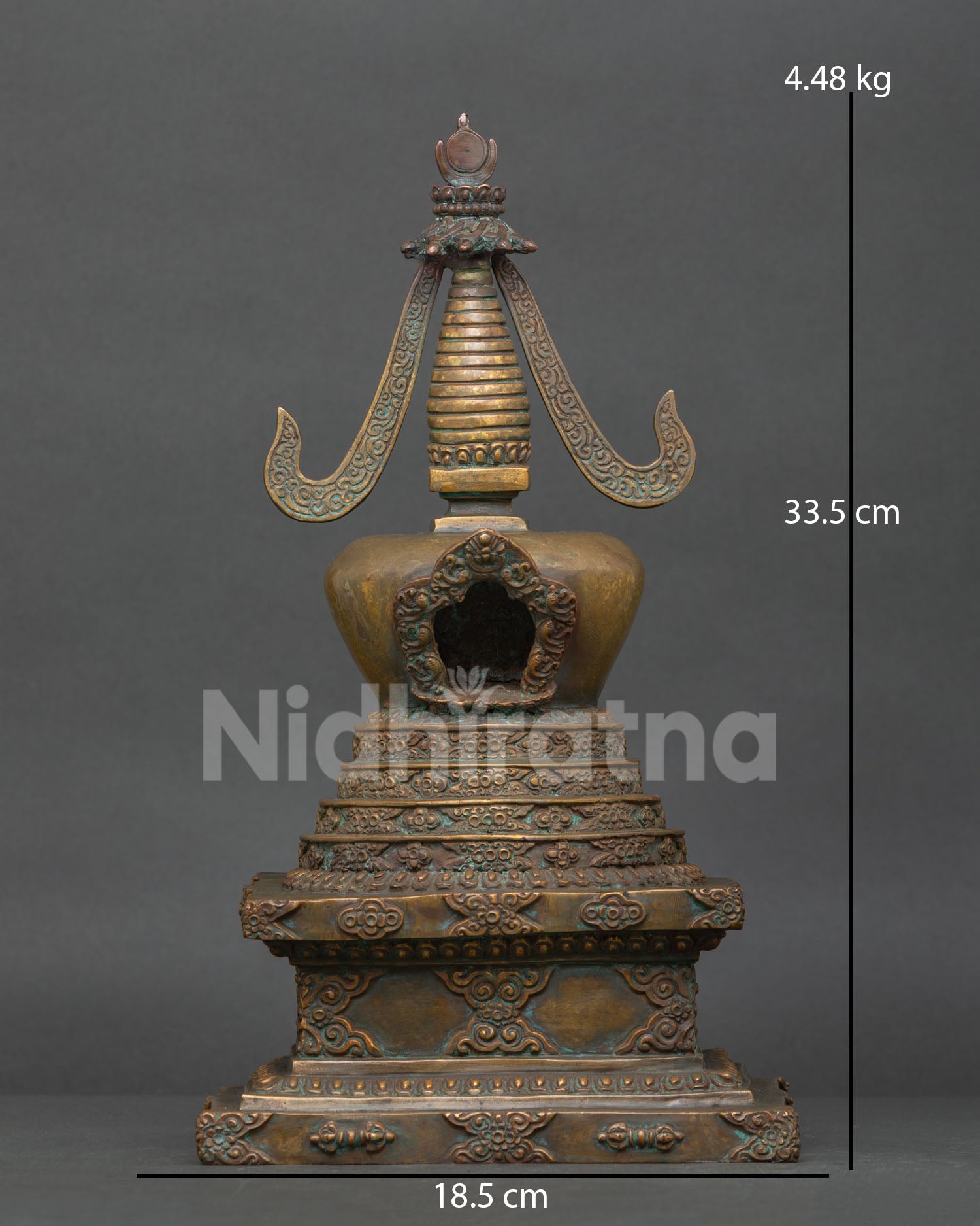 Traditional himalayan stupa with antique gold finish and patterned design.