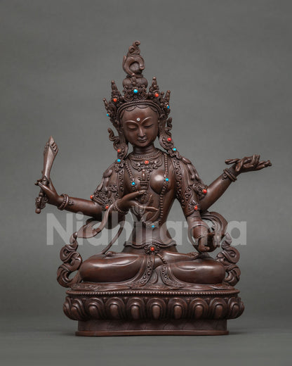 Trailokyavijaya Tara statue holding a vajra, victor over three worlds, oxidized copper