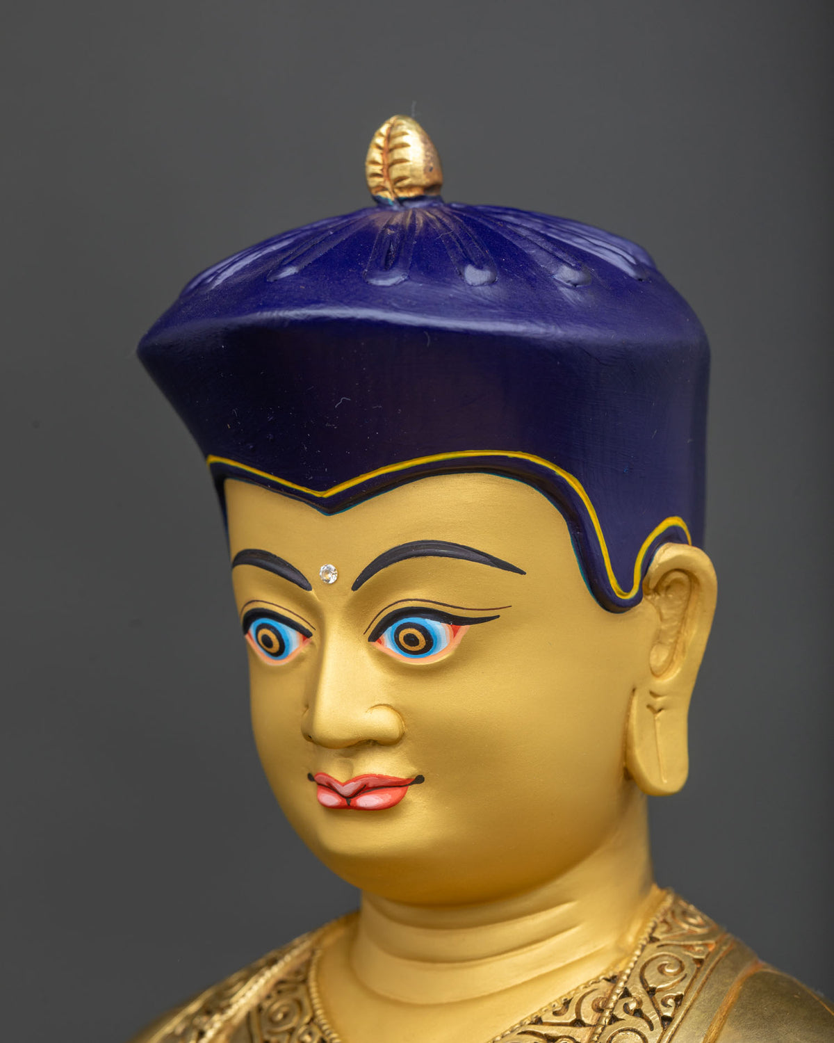 Tsangpa Gyare Statue side face close-up, blue crown and gold face detail