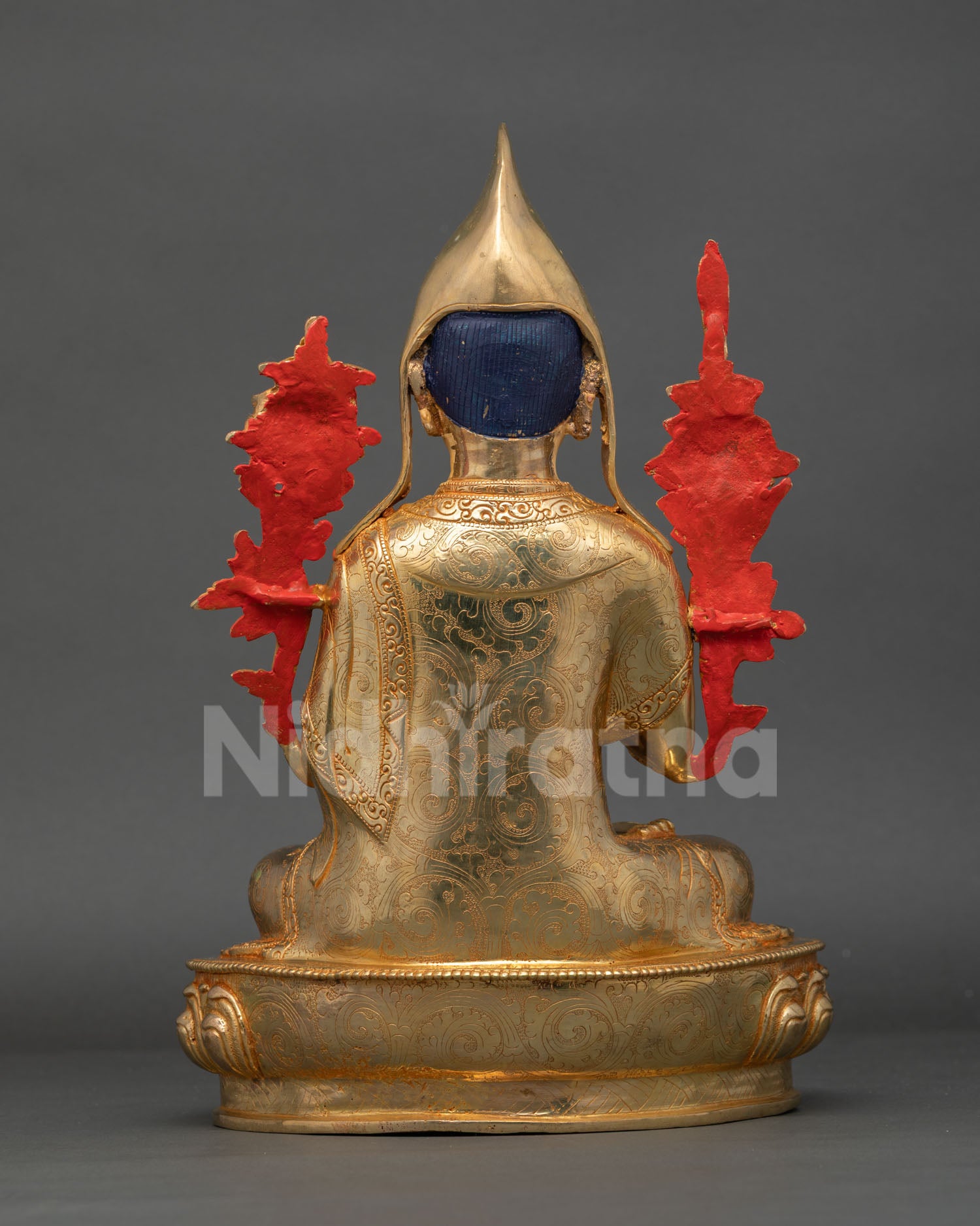 back view of handcrafted tsongkhapa statue showing detailed robe carving and traditional nepalese metalwork