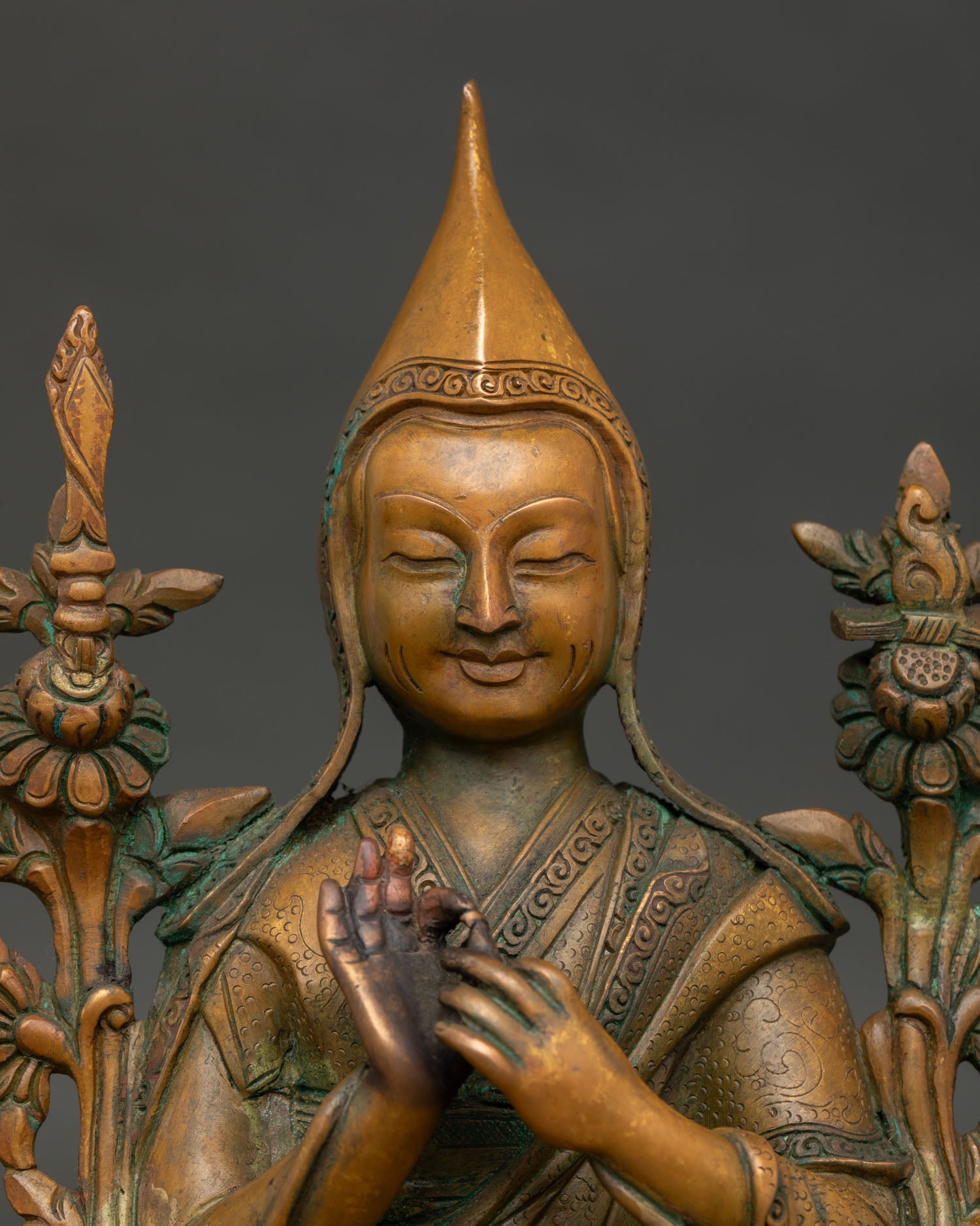 Tsongkhapa statue close up showing yellow pandita hat floral robes and antique oxidized copper finish.