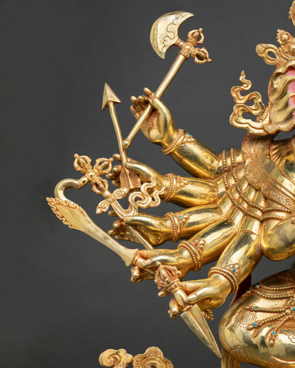 Twelve-armed Ganesh statue side profile with sword and trident details