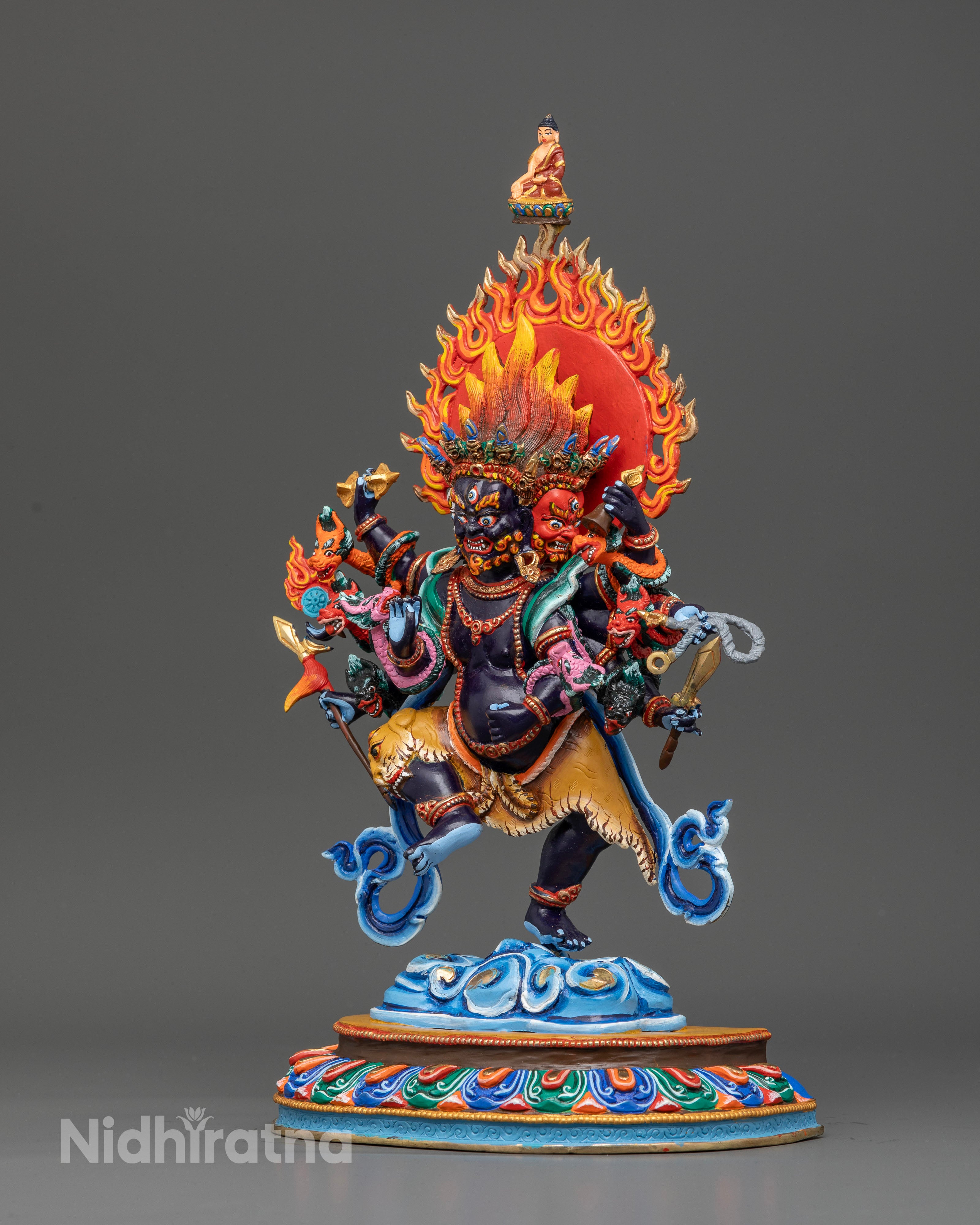Ucchusma Vajrayana deity statue with skull crown and tiger skin.