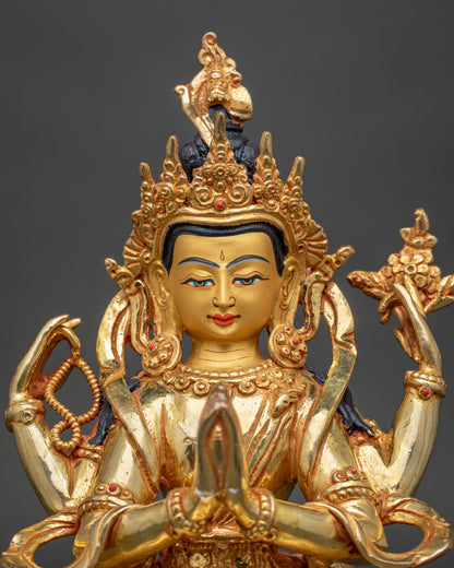 Upper body view of Four-Armed Chenrezig statue with gilded face, crown and prayer hands