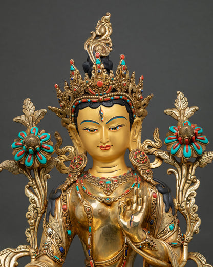 Upper body view of White Tara with jeweled crown and blooming utpala lotus flowers
