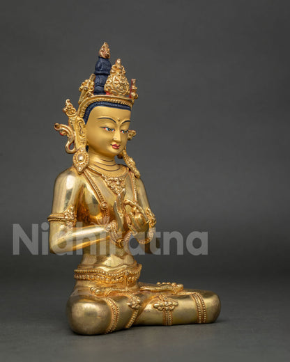 Vairocana Buddha statue seated in Padmasana with Dharmachakra Mudra.
