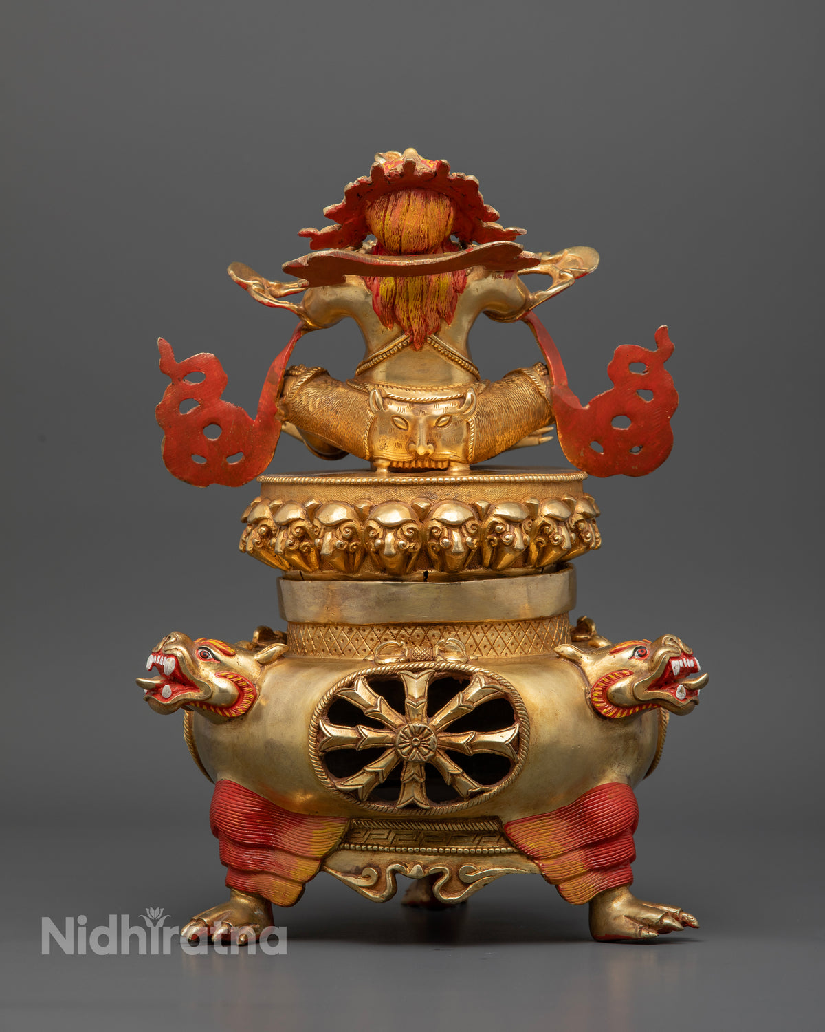 Vajradhaka statue with sacred motifs and engraved hollow lower chamber.