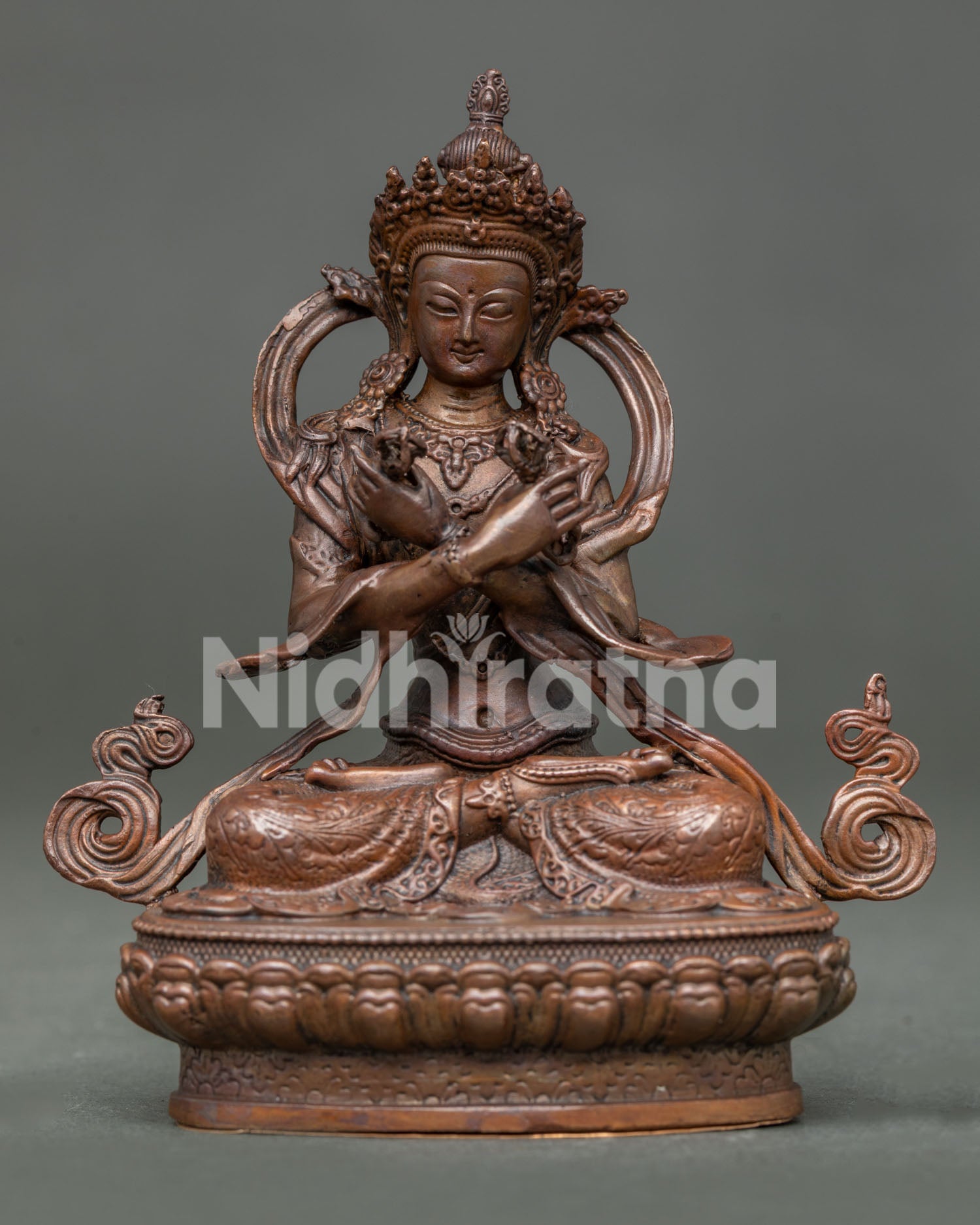Vajradhara buddha statue in vajraparyanka posture holding vajra and bell symbols of wisdom.