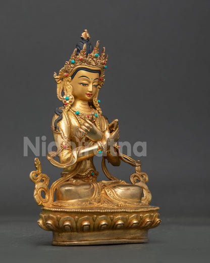 Vajradhara buddhist statue with 24k gold painted face vajra bell and semi precious stones.