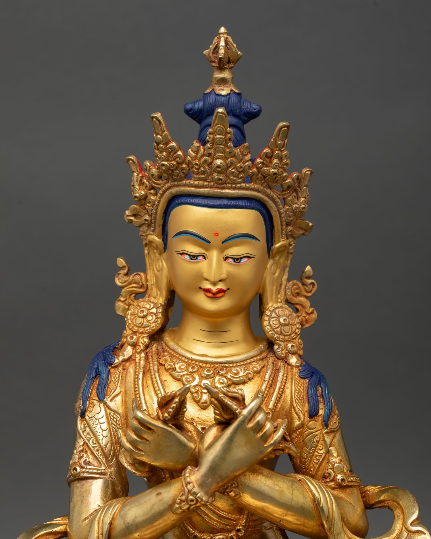 Vajradhara statue, close-up gold-painted face, intricate details, newari craftsmanship, Patan, Nepal, sacred sculpture