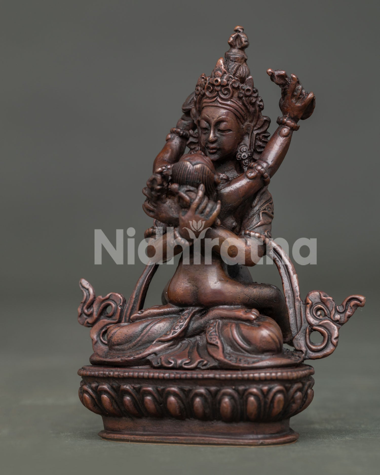 Vajradhara with consort detailed crowns and silk garments.