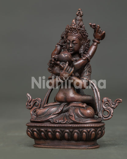 Vajradhara with consort detailed crowns and silk garments.