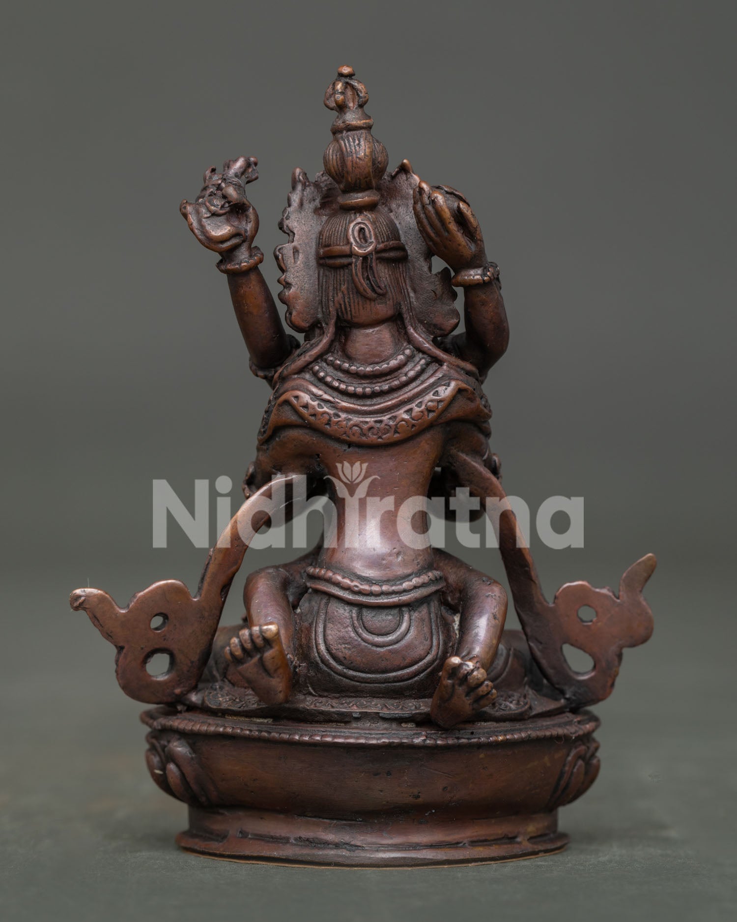 Vajradhara with consort statue back view showing handcarved silk garments.