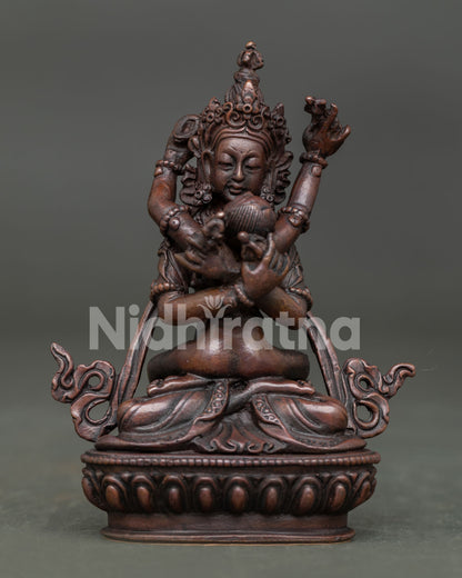 Vajradhara with consort statue front view in oxidized copper.