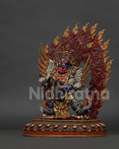 Vajrakilaya buddhist deity statue with phurba tiger skin and flaming halo.