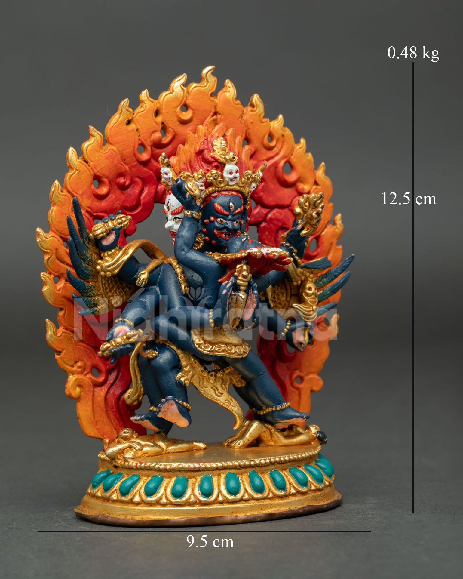 Vajrakilaya in sacred union with his consort featuring carved wings, gold gilding, and traditional Buddhist artistry.