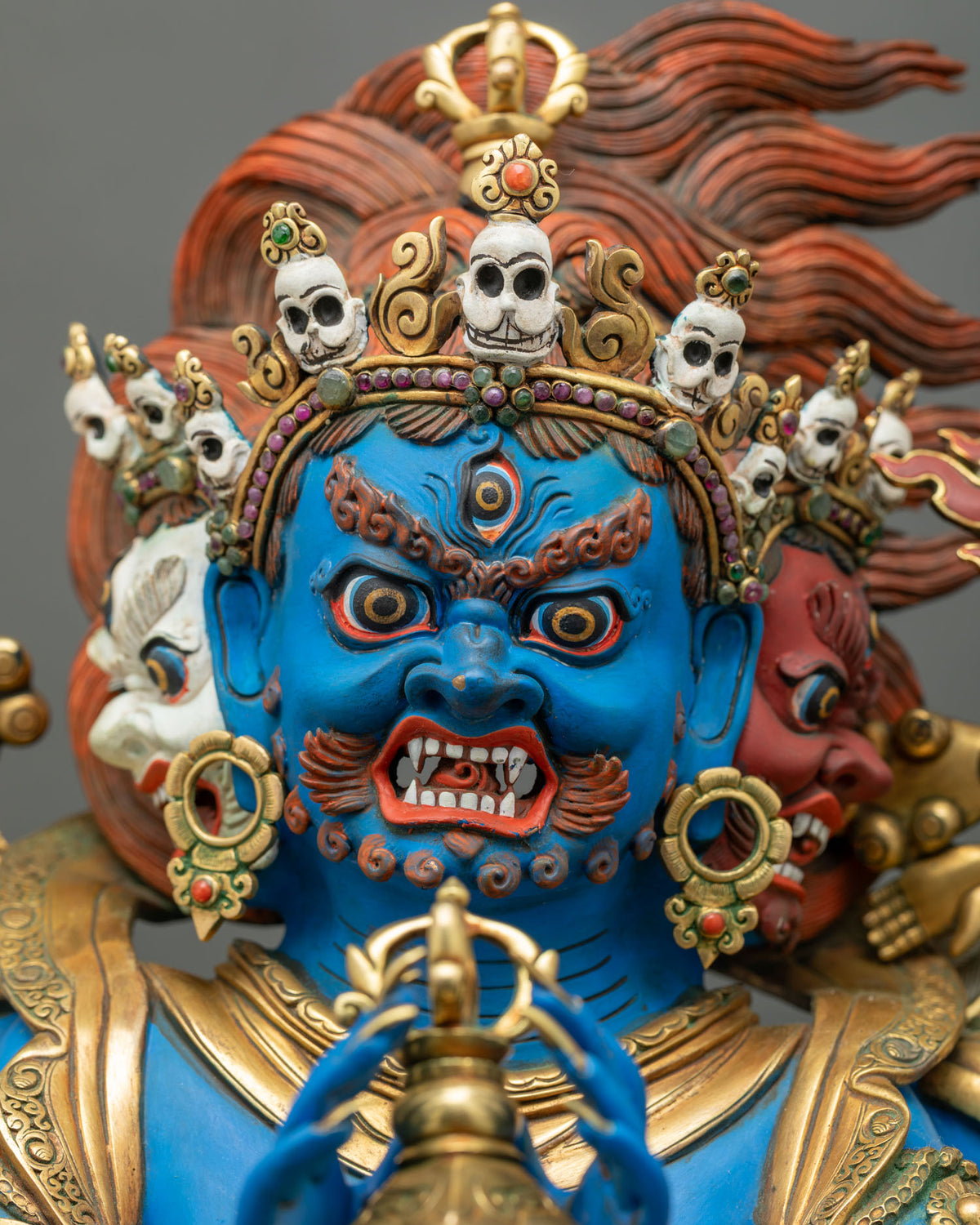 Vajrakilaya three-headed face close-up with white and red side faces, third eye and gemstone-set crown