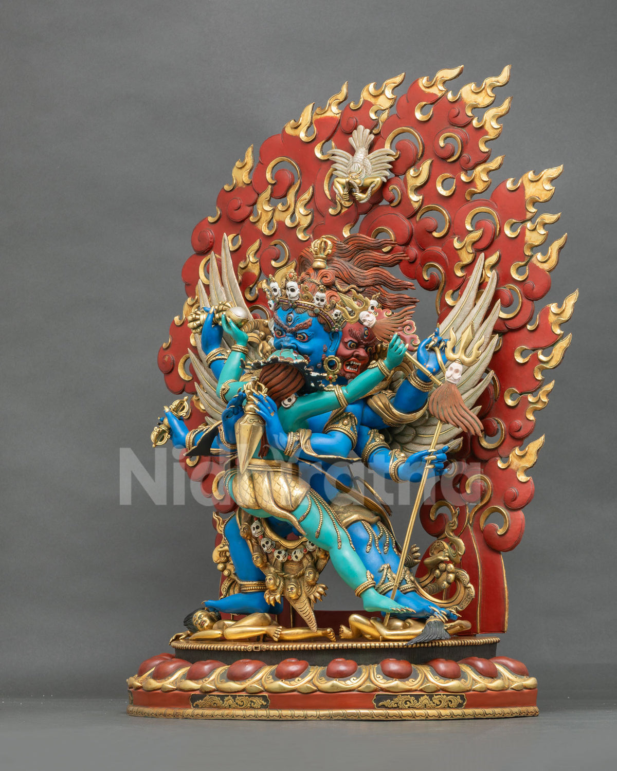 Vajrakilaya with consort side view showing red wrathful face, garuda wings and trident staff