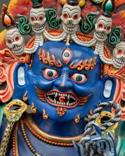 Vajrapani fierce blue face with ornate skull crown, wrathful expression and intricate jewelry closeup