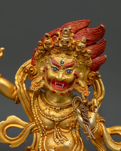 Vajrapani Statue Close Up with Gold Painted Face and Wrathful Expression.