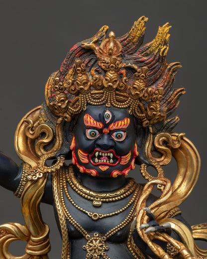 Vajrapani statue front closeup showing wrathful expression skull crown and ornate details.