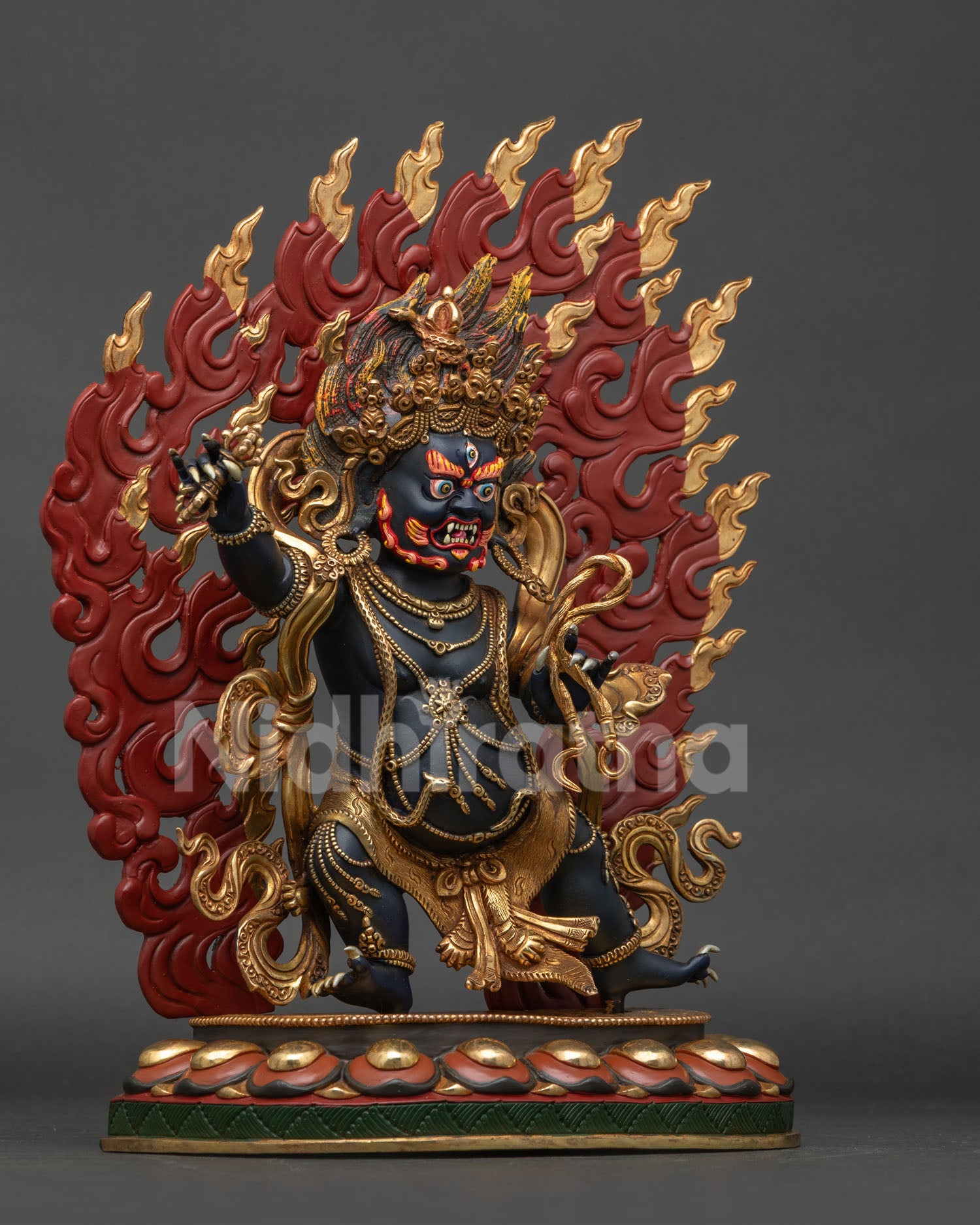 Vajrapani statue right view showing vajra lasso tiger skin and patterned flowing robe.