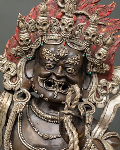 Vajrapani wrathful face close up showing fierce expression third eye and flaming hair details