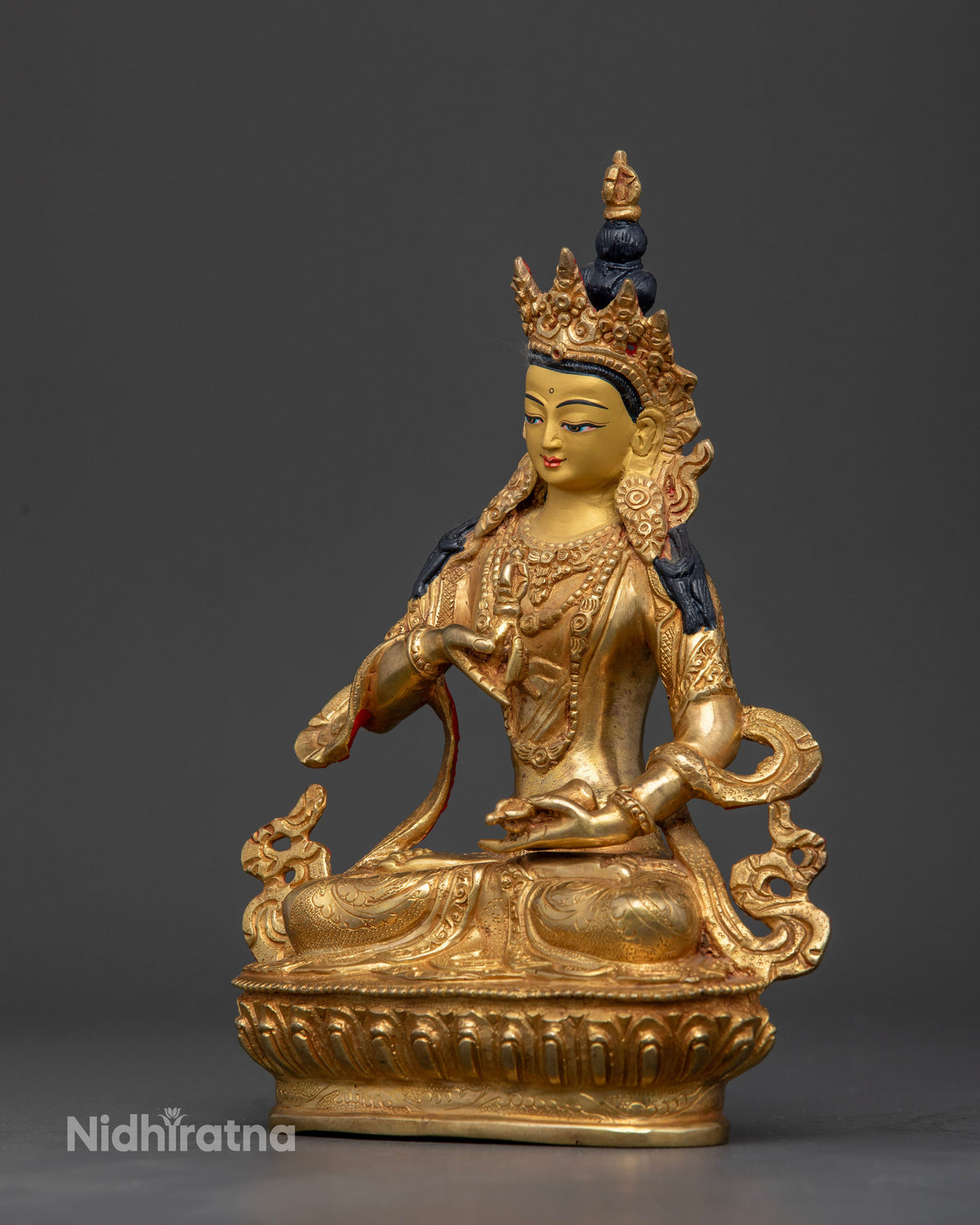 Vajrasattva Buddhist statue holding five pronged vajra and ritual bell.