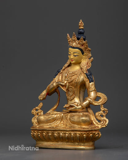 Vajrasattva Buddhist statue holding five pronged vajra and ritual bell.