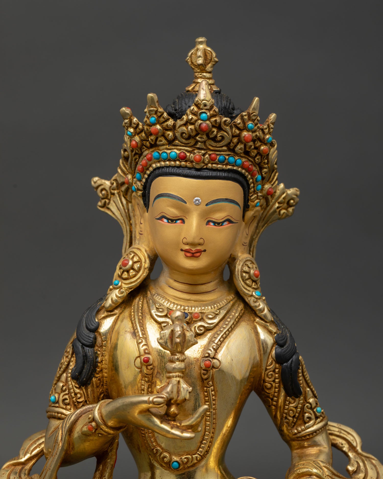Vajrasattva face close up gold painted serene expression Tibetan Buddhist iconography