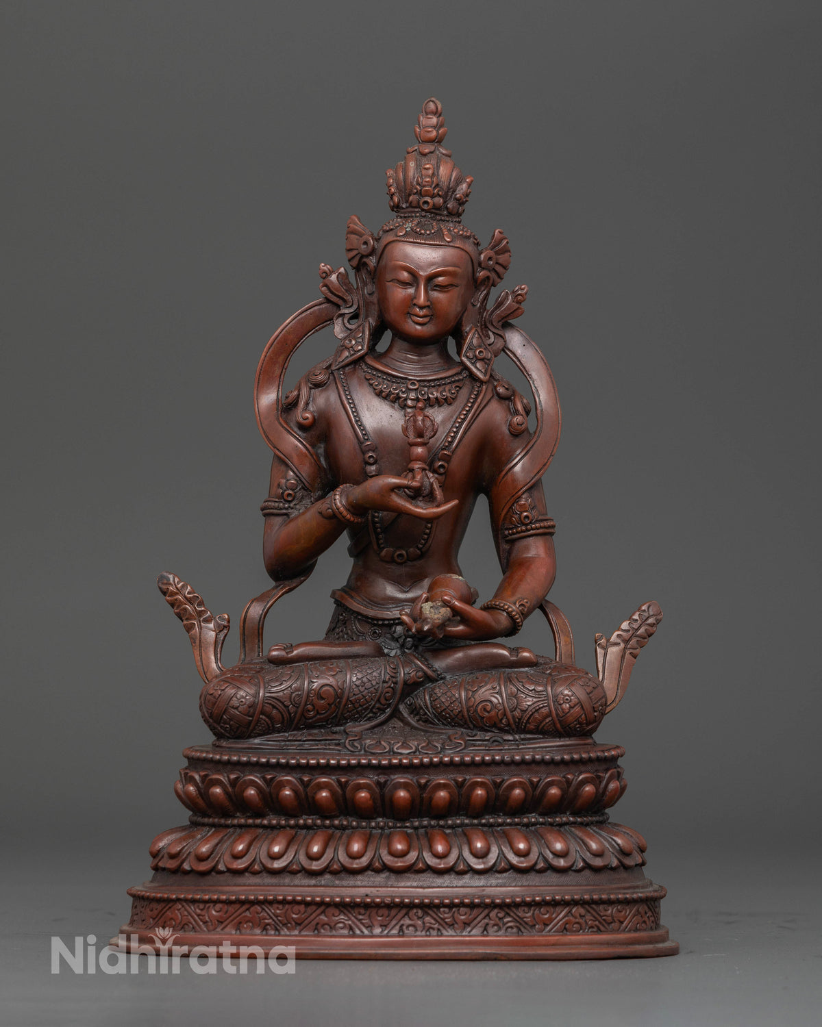 Vajrasattva seated on a double lotus pedestal holding vajra and bell