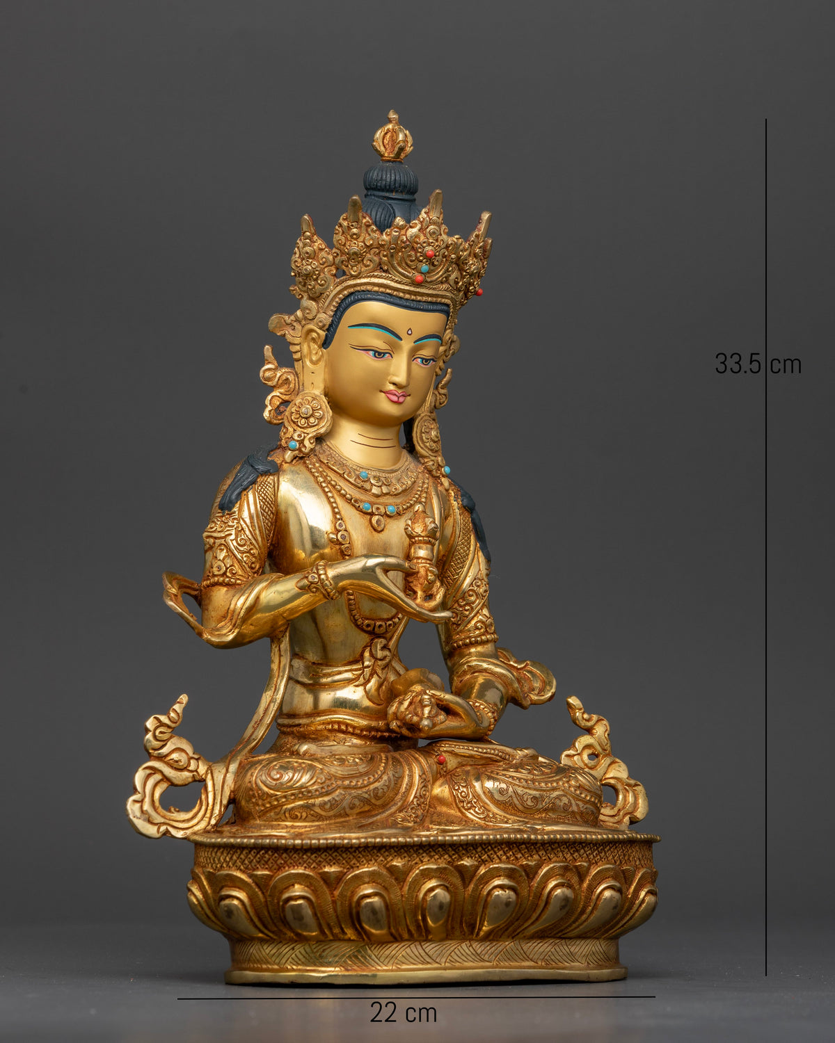 Vajrasattva seated on finely carved lotus pedestal holding vajra and bell.