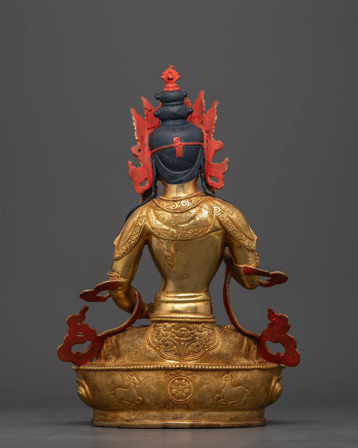Vajrasattva Statue back view intricate robe carvings floral motifs.