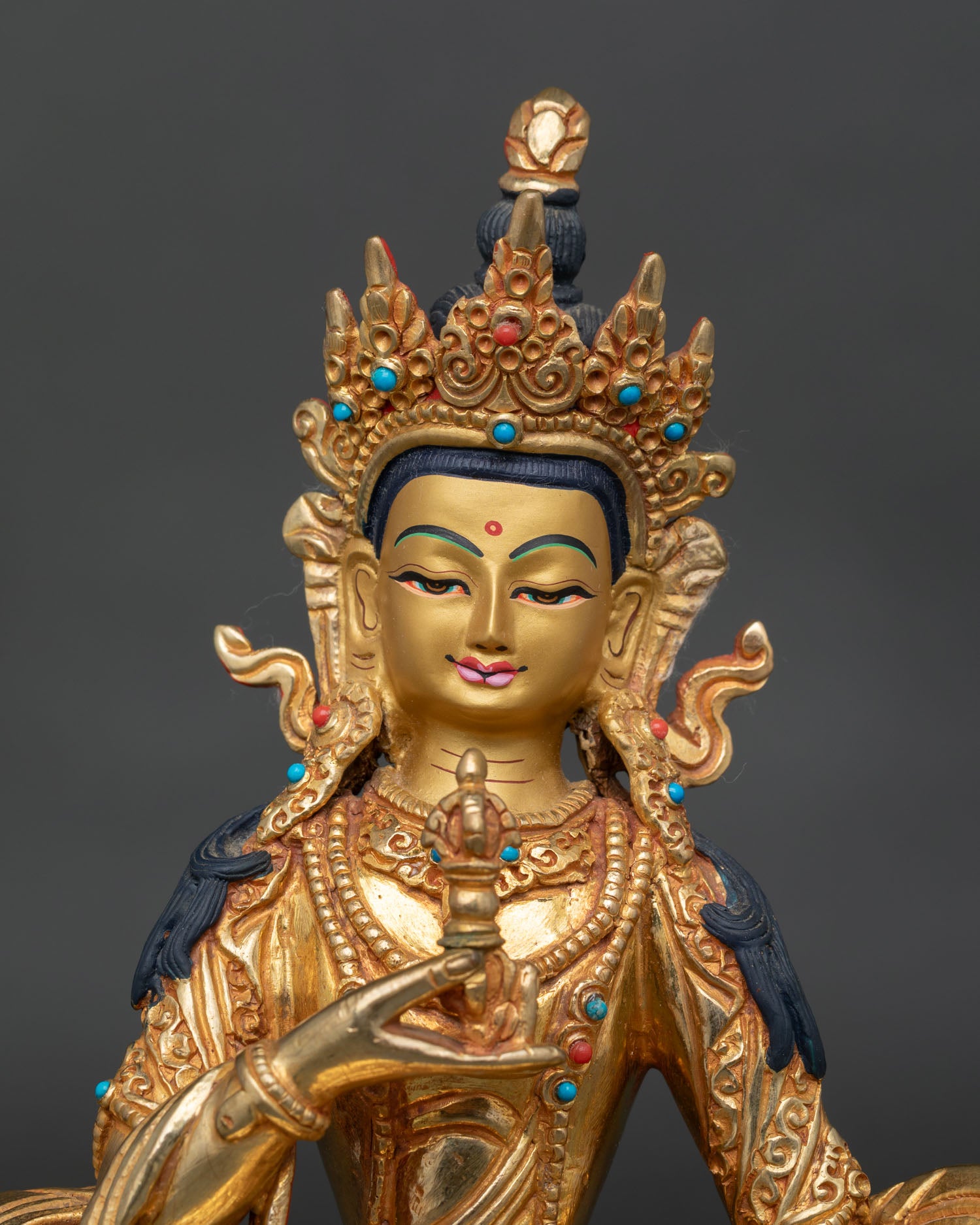 Vajrasattva statue close up, detailed handcrafted copper work with gold fire gilded finish